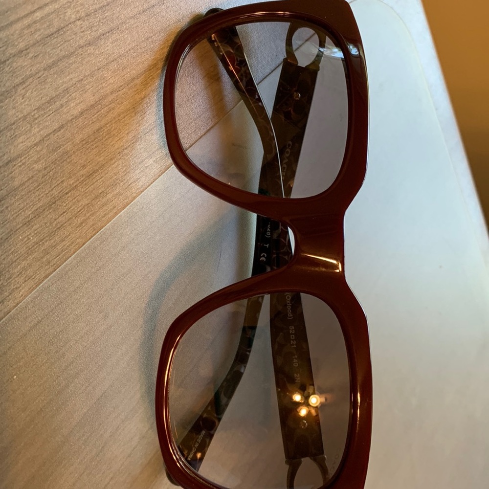 Coach women’s sunglasses Oxblood color. No tags but never worn, no scratches.